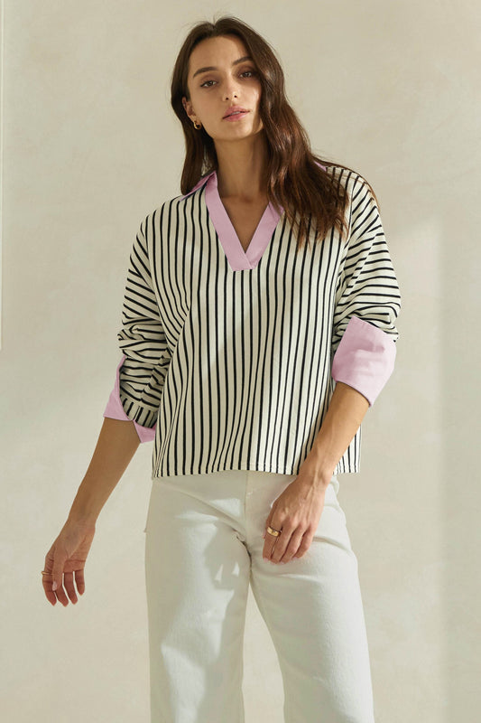A timeless striped knit top featuring a flattering V-neckline, contrast neckline and cuffs, and an effortlessly polished silhouette.