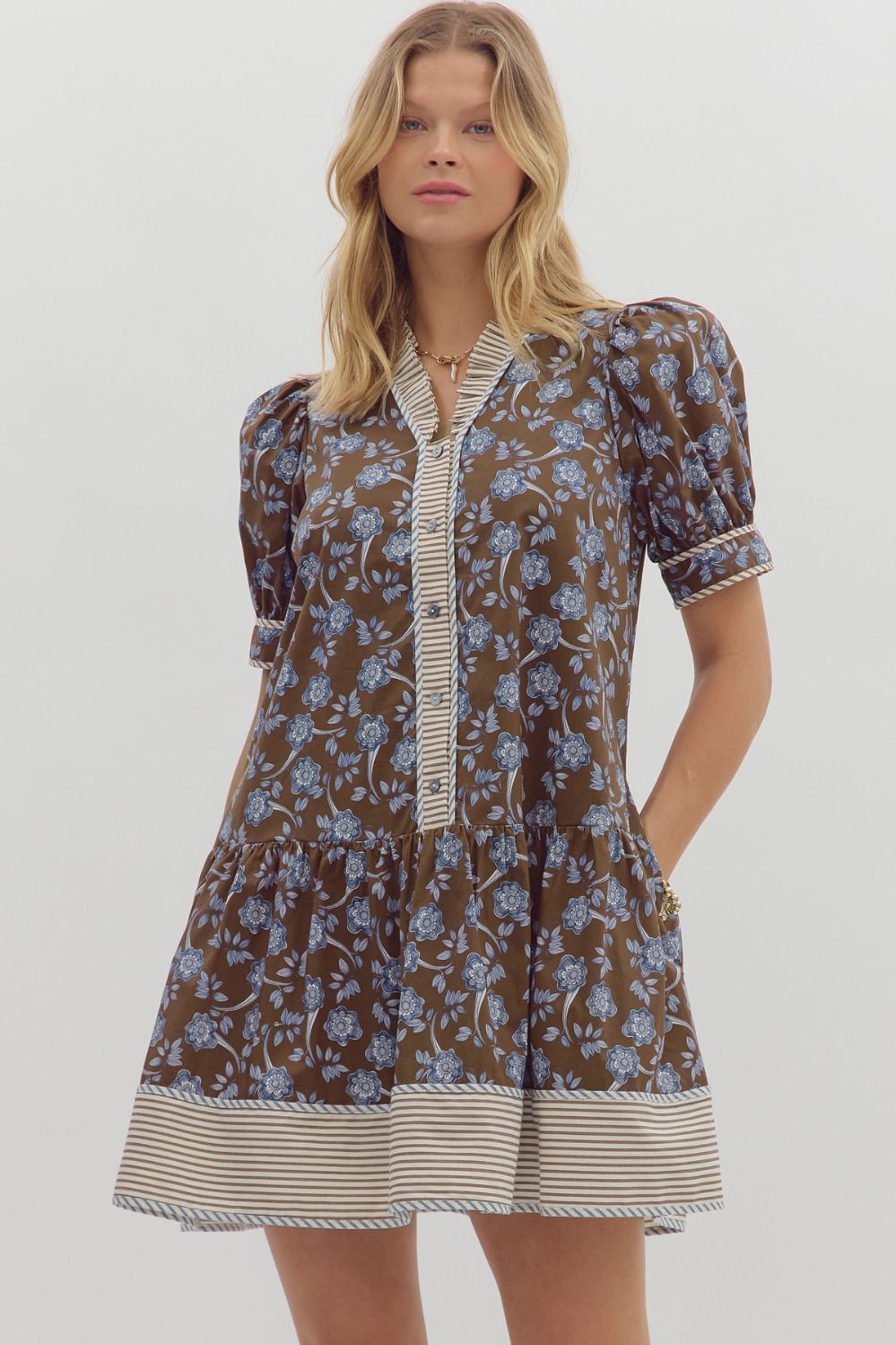 Structured puff sleeve floral mini with contrast hem and ruffle V-neckline.
