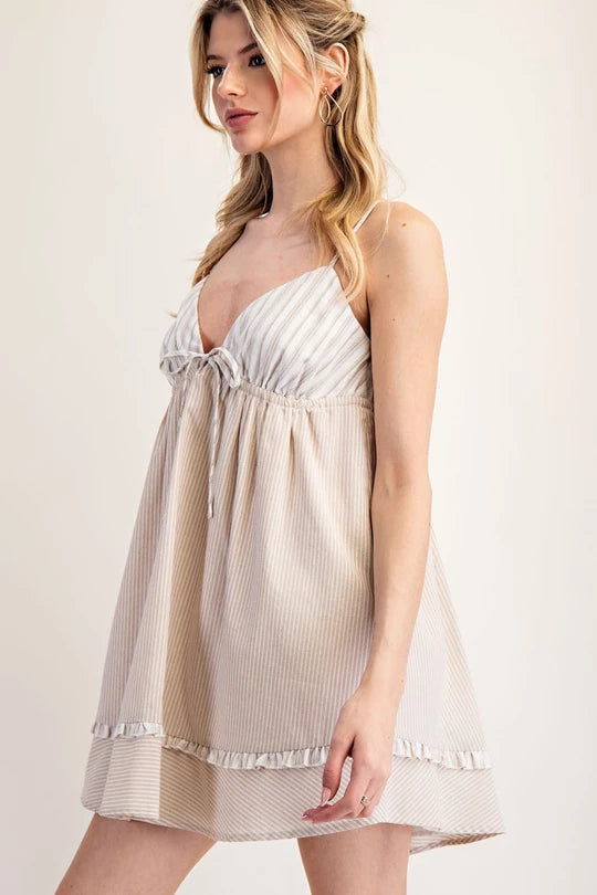 striped mini dress with a ruffled hem, featuring a plunging neckline and tie-front detail in beige and blue variations.
