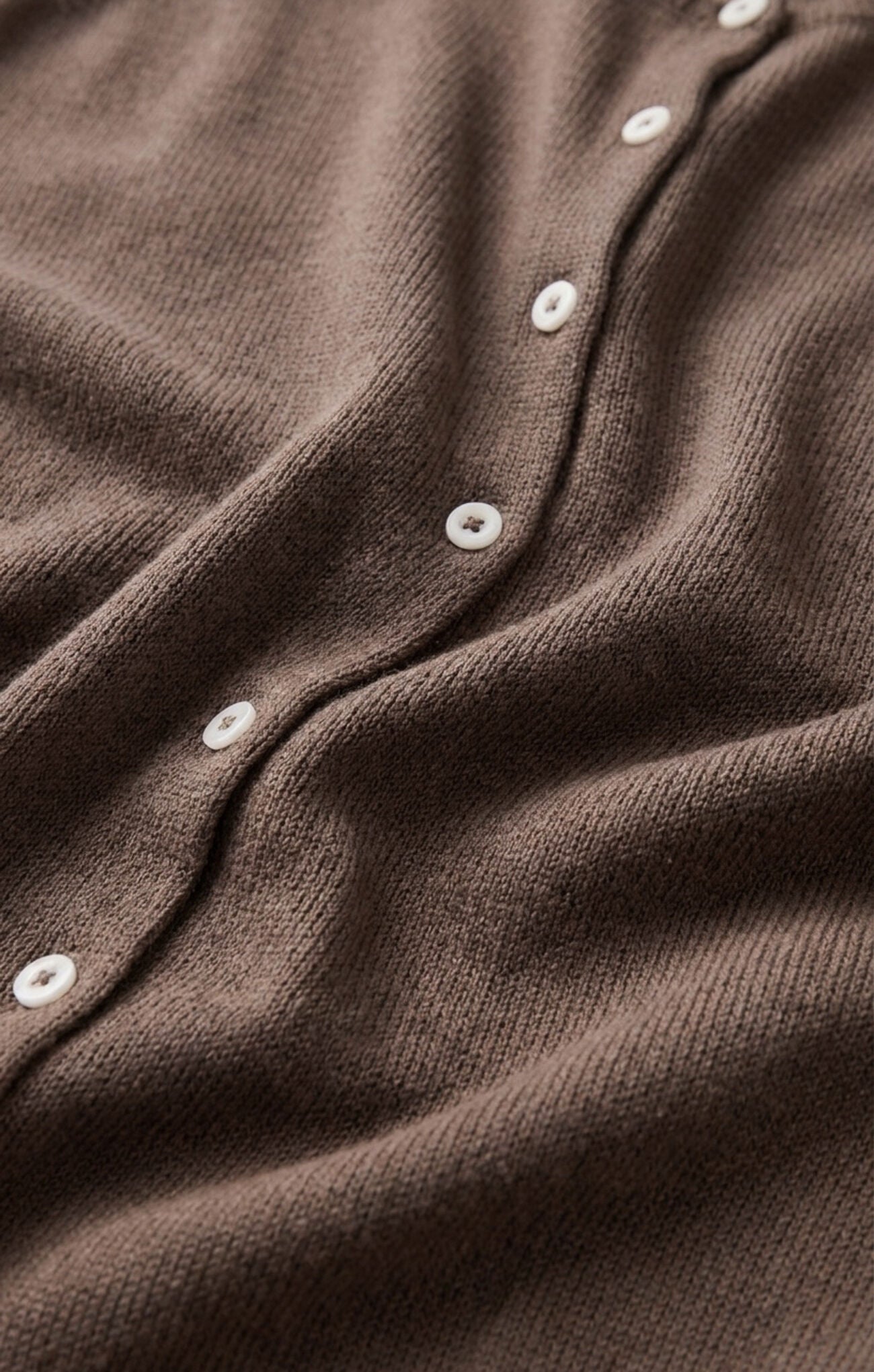 details of buttons on sweater vest