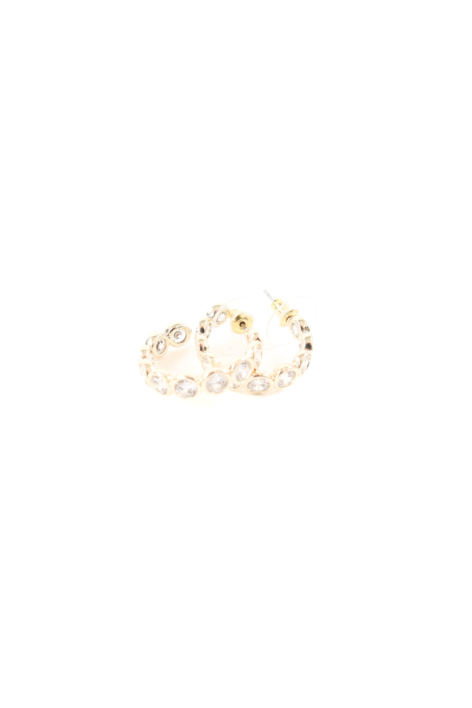 Gold hoop earrings featuring bezel-set clear crystals around the hoop