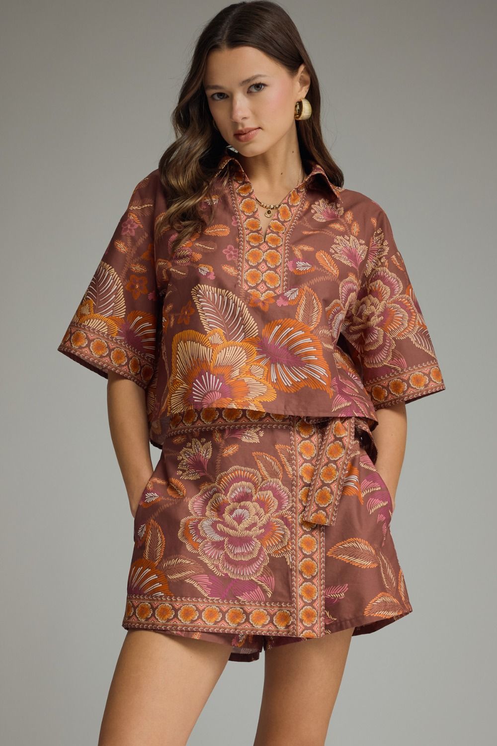 A feminine botanical print two-piece set featuring a breezy split-V top and wrap-front skort for effortless warm-weather style.