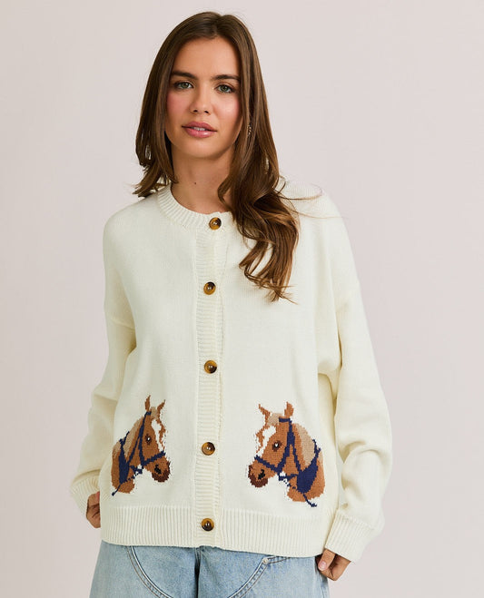 The Bernice Cardigan features a bold horse graphic design with a cozy knit blend, round neckline, and long sleeves for effortless statement layering.

