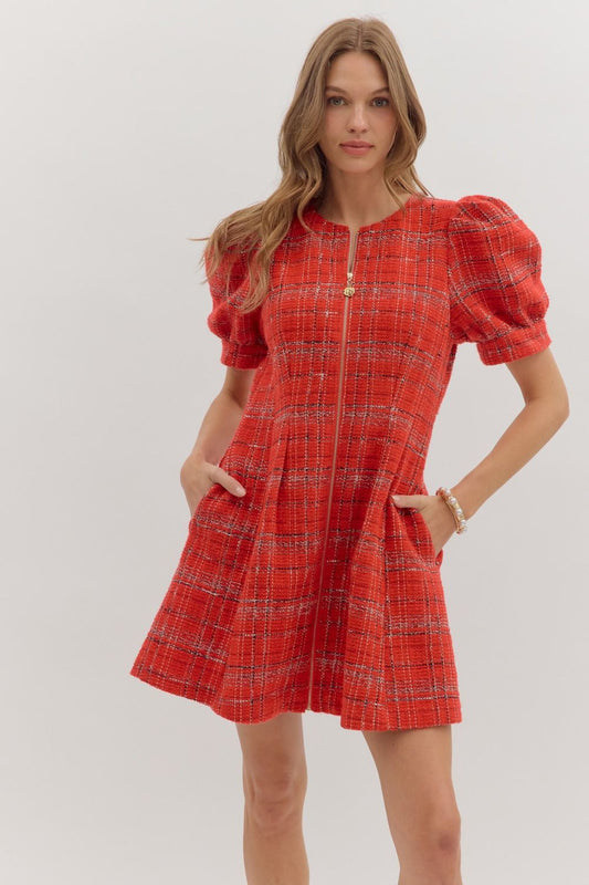 The Camille Plaid Mini Dress features playful short sleeves, a front zipper, and practical side pockets for versatile style.

