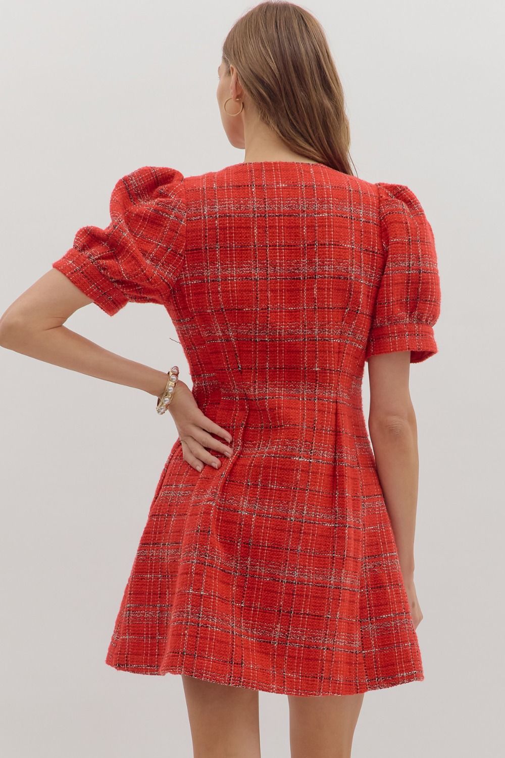 The Camille Plaid Mini Dress features playful short sleeves, a front zipper, and practical side pockets for versatile style.

