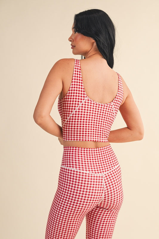 The Charlotte Gingham Performance Top features quick-drying, breathable fabric with four-way stretch and a removable bra pad for all-day comfort.
