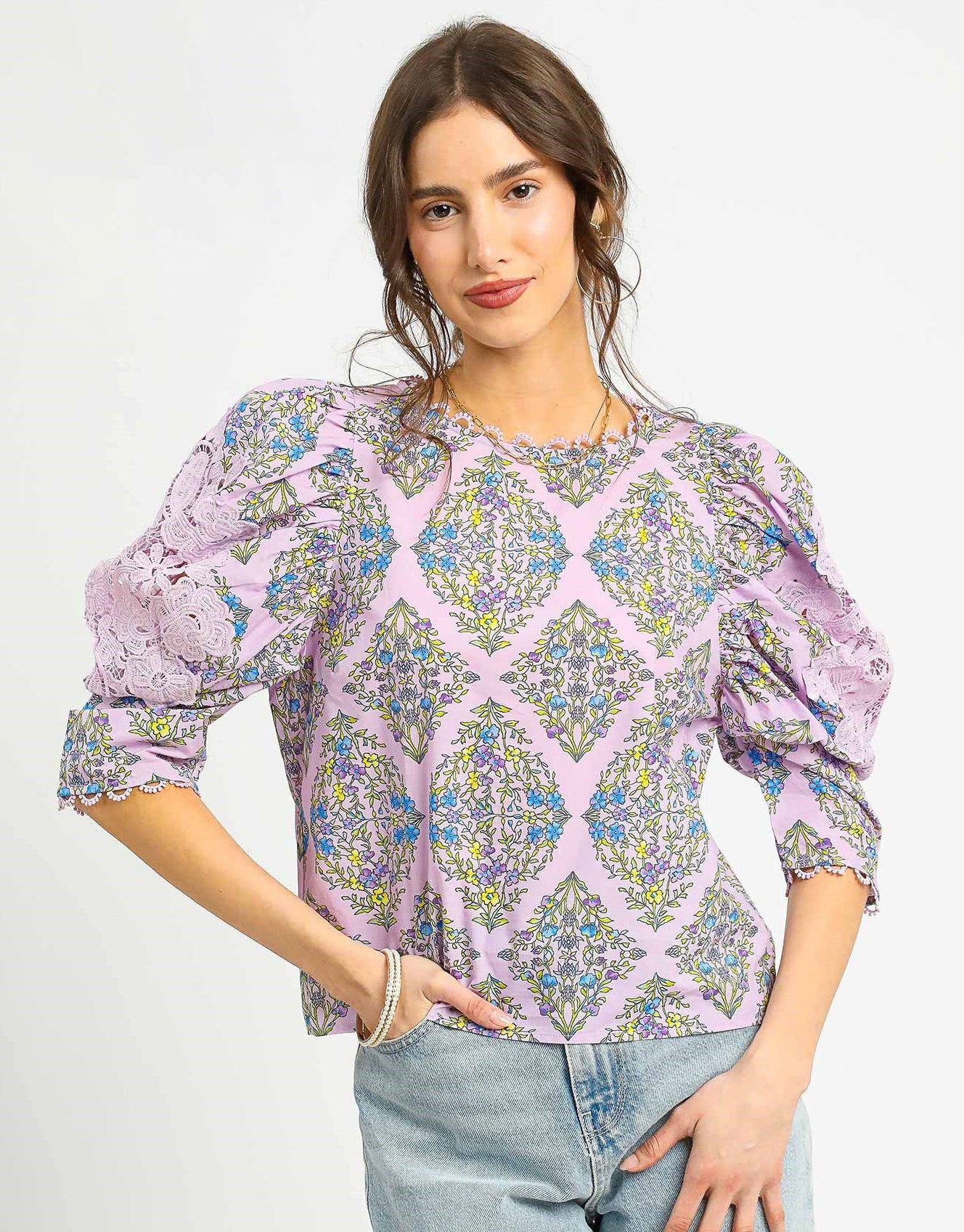 The Claudine Vintage Floral Blouse showcases a romantic floral print with statement puff sleeves, lace insets, and a scalloped crochet neckline for timeless charm.

