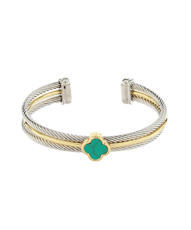 A two-tone cuff bracelet featuring a silver-toned cable twist design accented with a gold-toned band, centered with a turquoise-colored four-leaf clover motif.