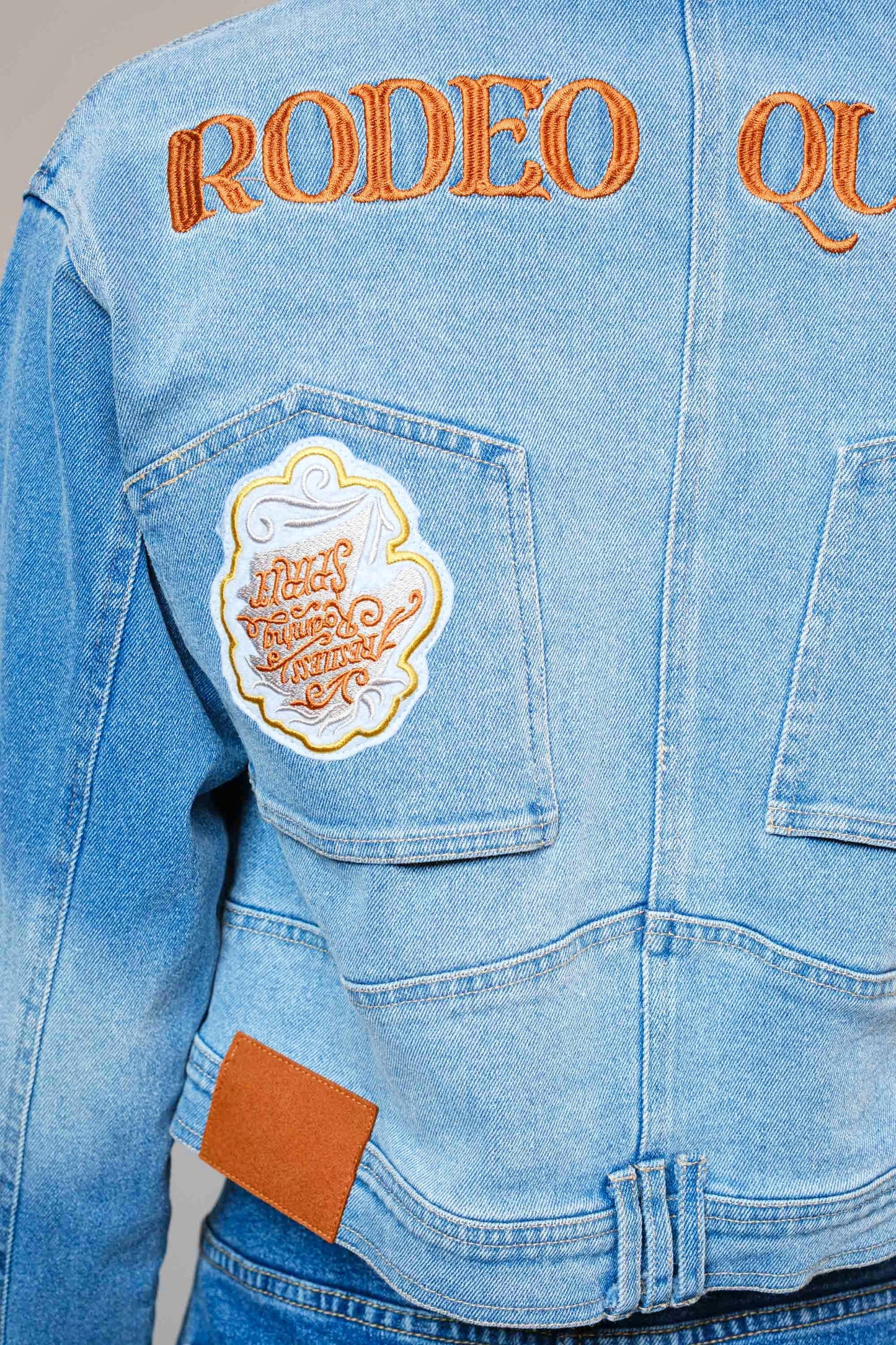 The Effie Jacket is a cropped denim essential with contrast patchwork, Western embroidery, and bold “Rodeo Queen” lettering on the back.