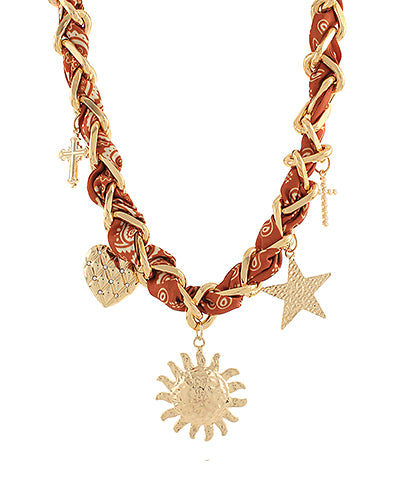 The Esme Charm Scarf Necklace combines layered metal accents and soft fabric ties for a playful, boho-inspired finish.