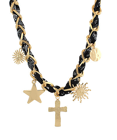 The Esme Charm Scarf Necklace combines layered metal accents and soft fabric ties for a playful, boho-inspired finish.