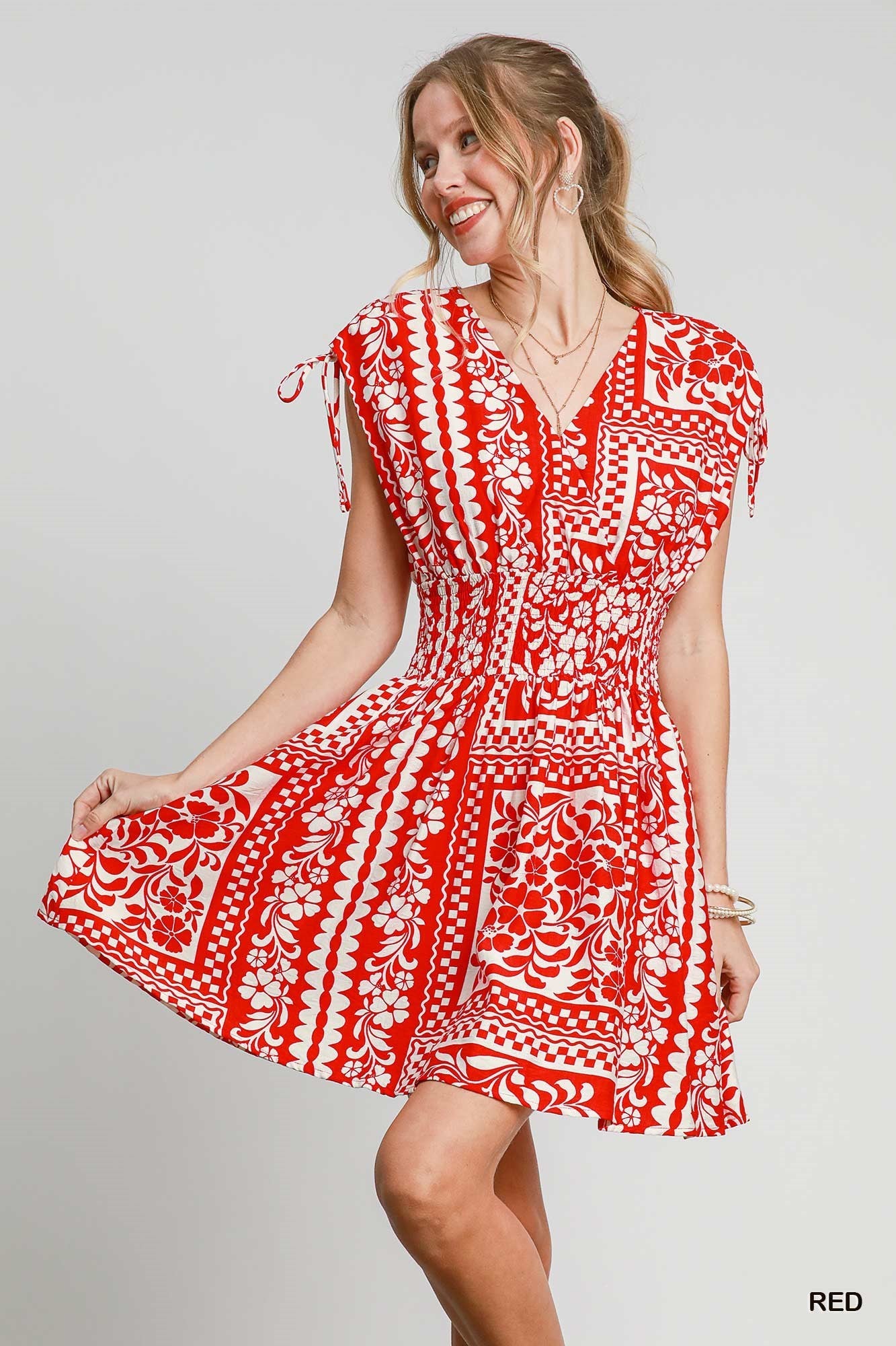 The Evangeline Boho Mini Dress features a smocked elastic waist, adjustable tie sleeves, and a breezy flared skirt with side pockets—perfect for effortless, free-spirited style.

