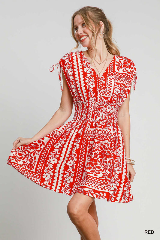 The Evangeline Boho Mini Dress features a smocked elastic waist, adjustable tie sleeves, and a breezy flared skirt with side pockets—perfect for effortless, free-spirited style.


