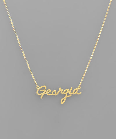 The Georgia State Necklace features a delicate script nameplate showcasing state pride with elegant style.

