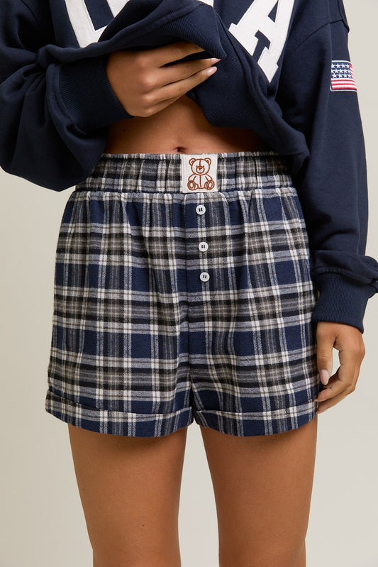 The Hilda Shorts feature a high-waisted fit and classic plaid pattern for a chic and comfortable everyday style.

