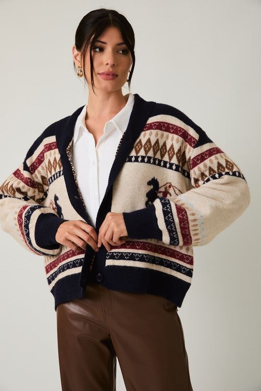 The Laverne Cardigan is an oversized sweater with a bold horse graphic and cozy button-up styling—perfect for equestrian-inspired layering this season.

