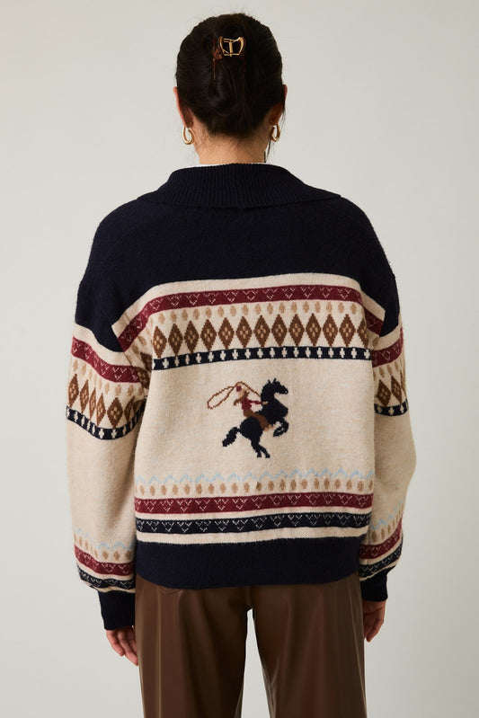 The Laverne Cardigan is an oversized sweater with a bold horse graphic and cozy button-up styling—perfect for equestrian-inspired layering this season.

