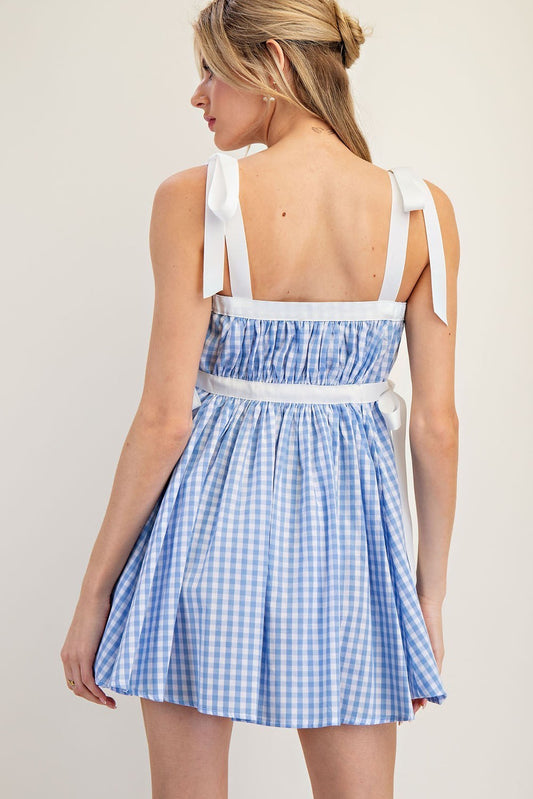 The Lilia Dress is a feminine gingham mini with adjustable bow-tie straps, a ruched bodice, and a flared skirt—perfect for summer outings, brunches, or vacations.

