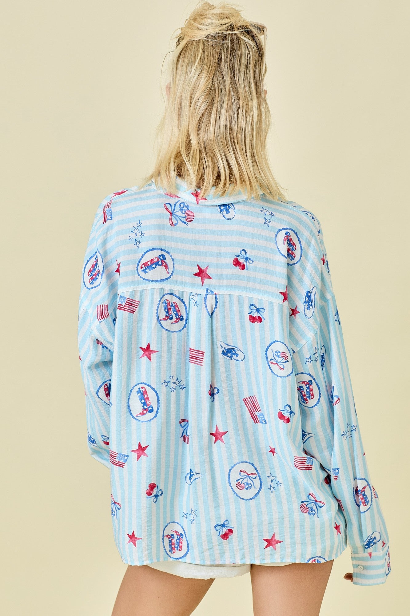 The Lucinda Shirt channels effortless Americana style with classic red, white, and blue stripes, a collared neckline, and an easy button-down fit.


