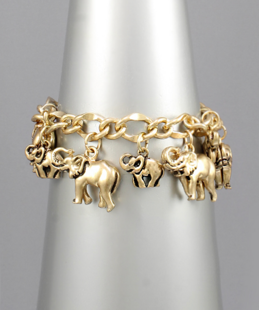  A vibrant gold-toned charm bracelet adorned with multiple detailed elephant charms of various sizes and designs, some solid and some with cutout patterns, all suspended from an intricate chain.