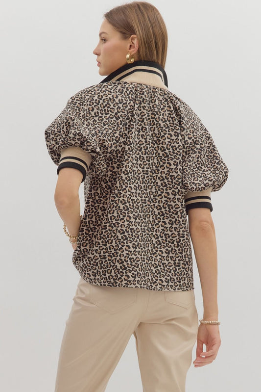 The Lula Leopard Puff Sleeve Top combines playful print, vibrant accents, and a flattering half-zip neckline for a standout everyday look.