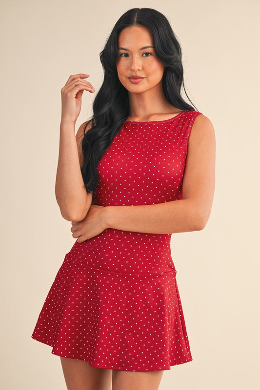 The Marlo Polka Dot Mini Dress features a modern drop waist and sporty polka dot print in a stretchy, breathable knit for all-day comfort.