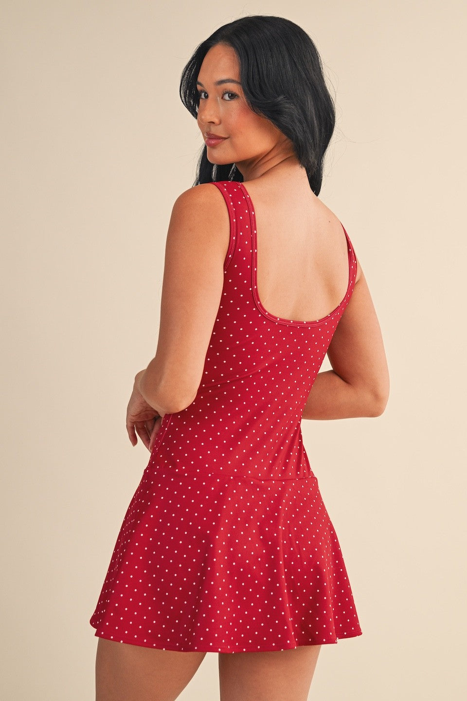 The Marlo Polka Dot Mini Dress features a modern drop waist and sporty polka dot print in a stretchy, breathable knit for all-day comfort.