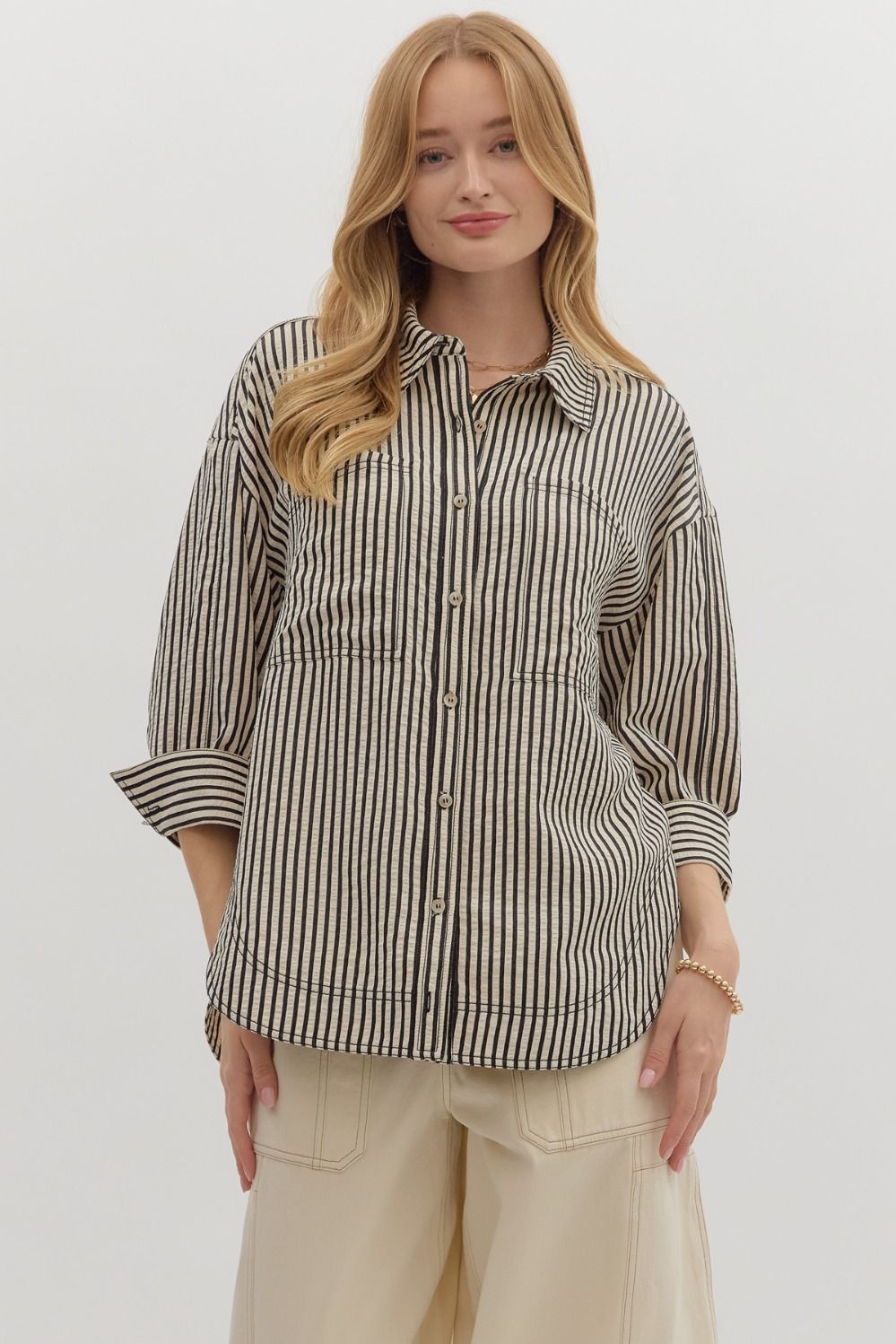 The Mavis Shirt delivers casual polish with its textured stripe pattern, cuffed ¾ sleeves, and double front pockets—ideal for layering or wearing solo.

