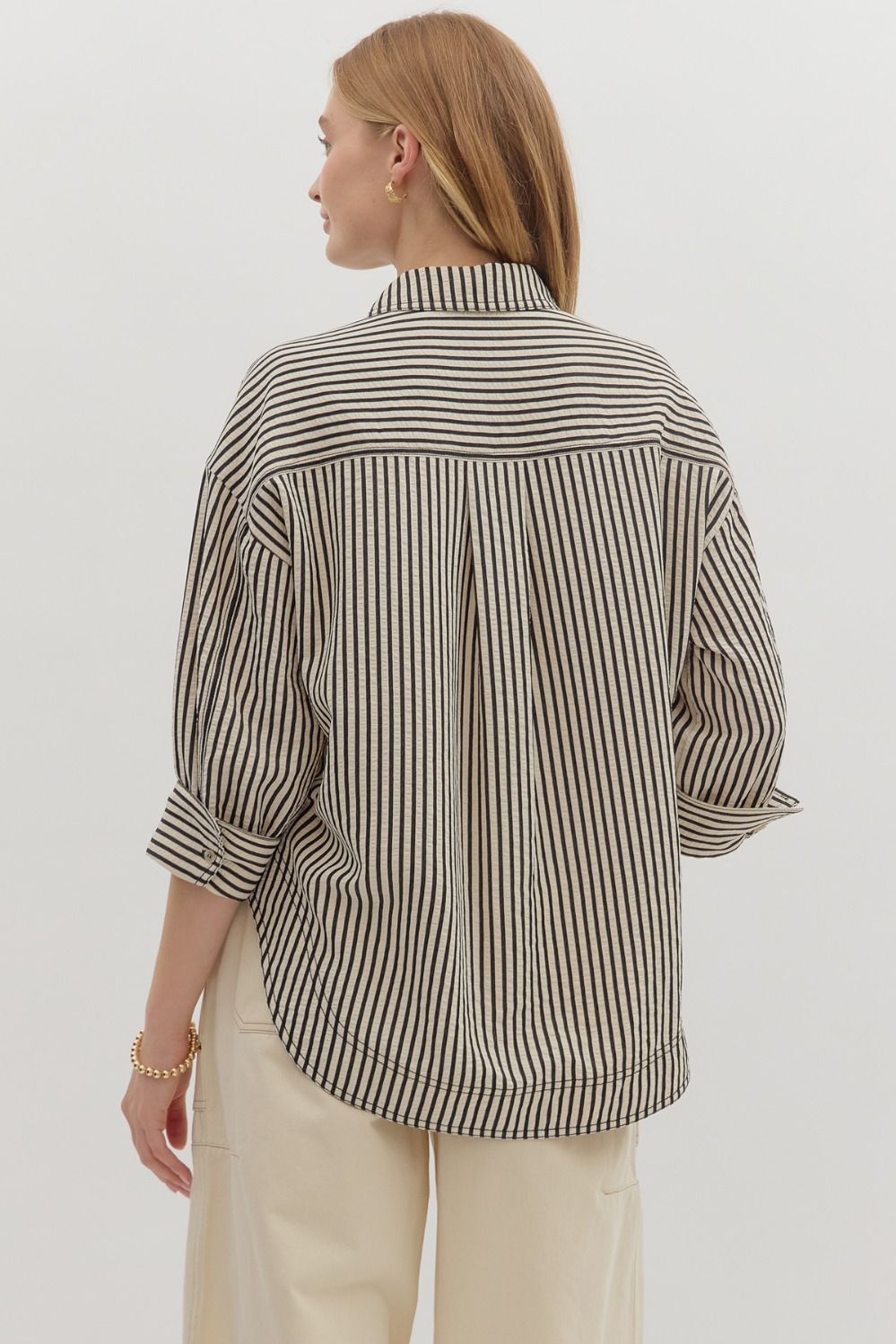 The Mavis Shirt delivers casual polish with its textured stripe pattern, cuffed ¾ sleeves, and double front pockets—ideal for layering or wearing solo.

