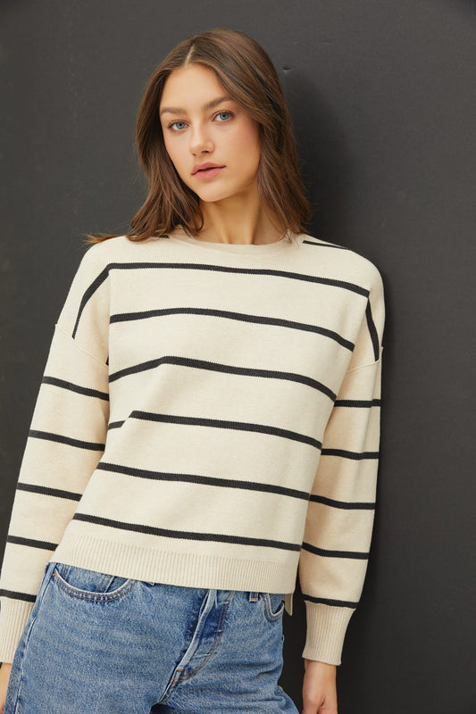 The Maxine Sweater is a cozy striped knit with a boxy oversized fit, stepped high-low hem, and casual-chic drop shoulders.

