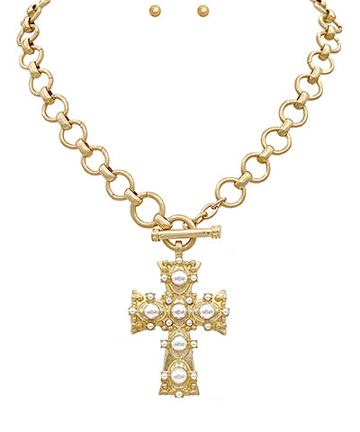 The Miriam Necklace Set features a delicate 16" chain accented with faux pearls and a cross pendant, secured with lobster clasp and toggle closure for versatile wear.

