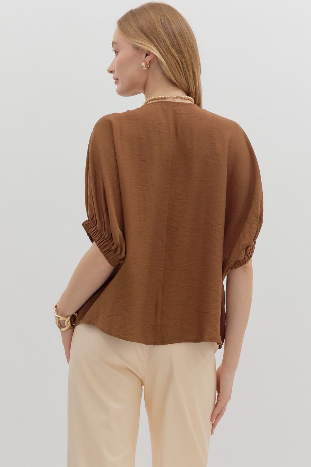 The Nadine Top features an airy dolman silhouette with a unique trenza-detailed V-neckline. Lightweight and effortless, it’s the perfect blend of comfort and elevated style.