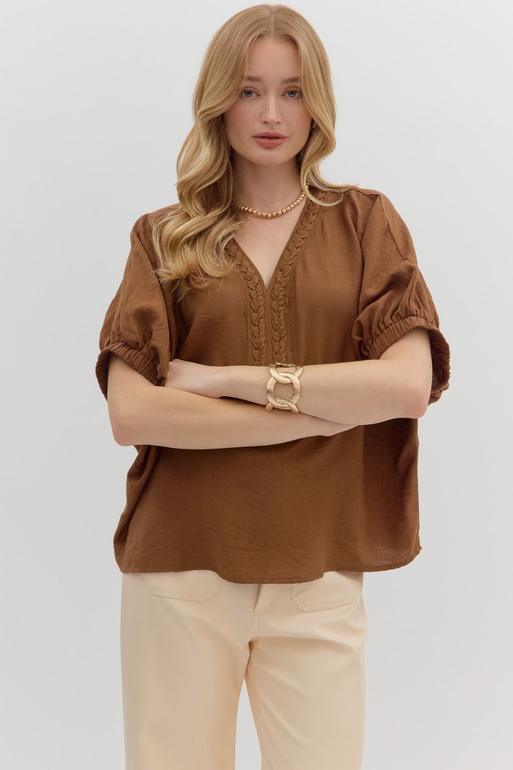 The Nadine Top features an airy dolman silhouette with a unique trenza-detailed V-neckline. Lightweight and effortless, it’s the perfect blend of comfort and elevated style.