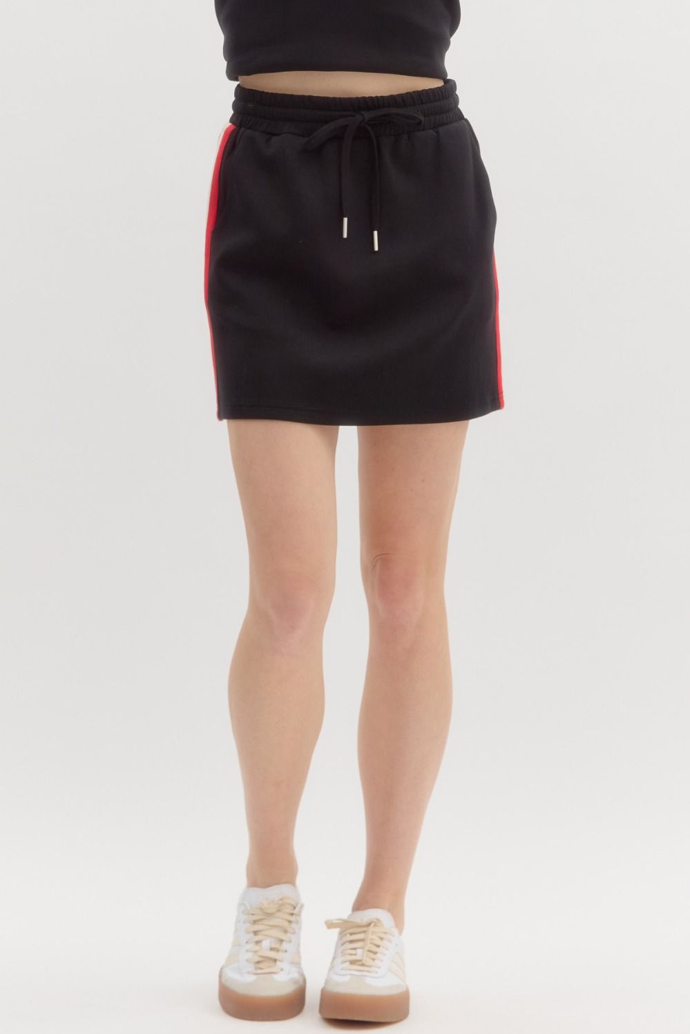 The Noelle Skirt features a comfy pull-on fit with bold multicolor side stripes and pockets—made for casual days with a sporty twist.