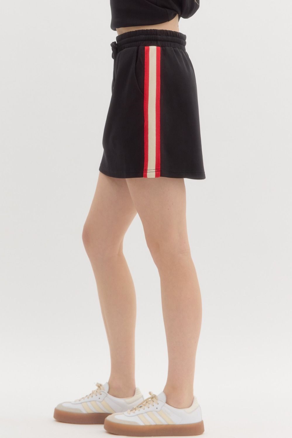 The Noelle Skirt features a comfy pull-on fit with bold multicolor side stripes and pockets—made for casual days with a sporty twist.
