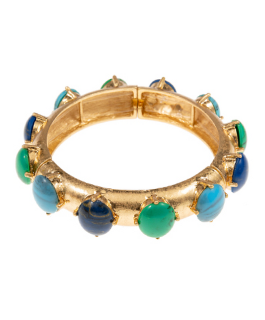 A vibrant gold-toned bangle bracelet featuring a series of alternating smooth and striped cabochon stones in shades of teal, blue, and green.