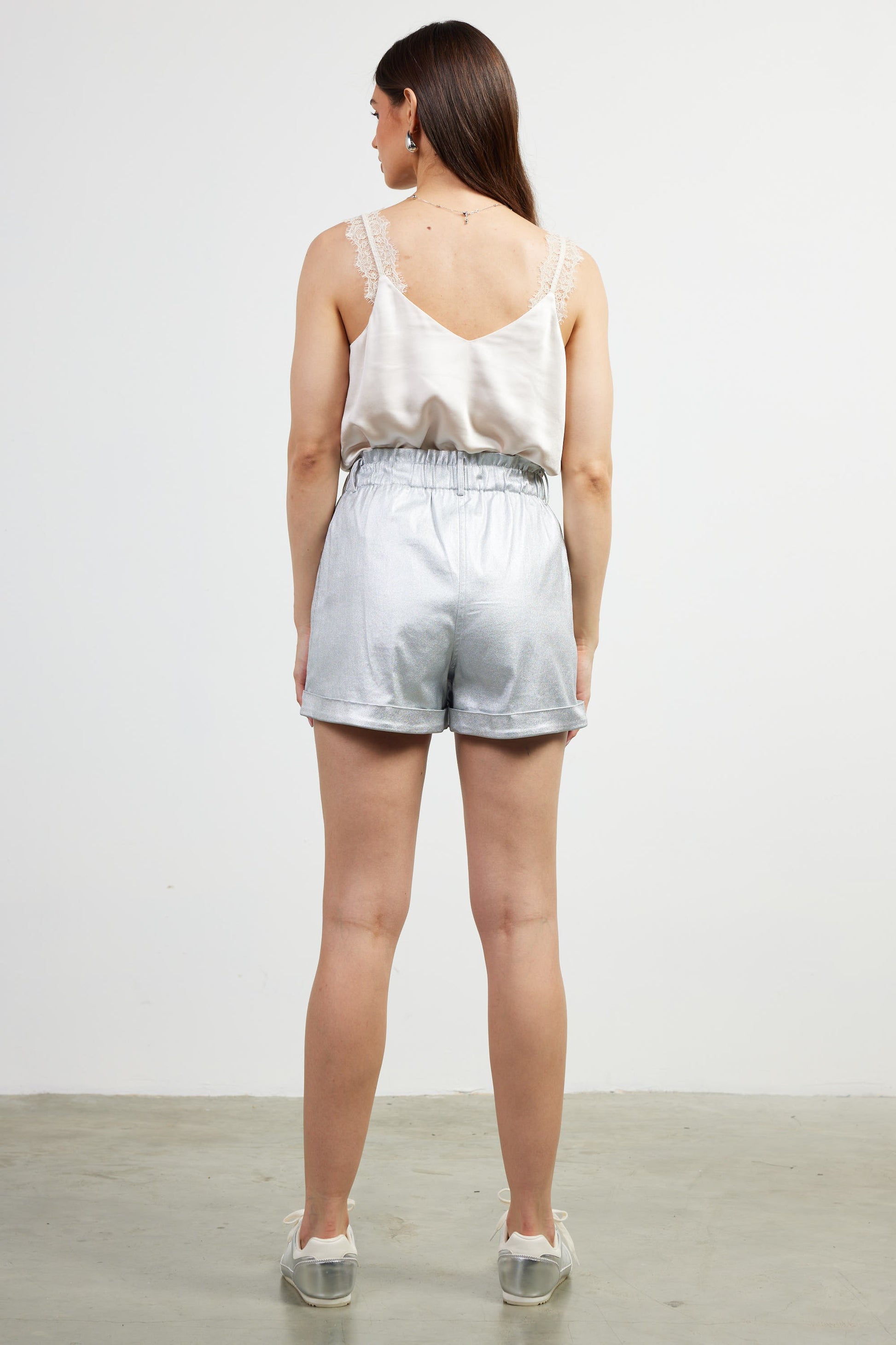 The Odessa Shorts shimmer with silver and bronze tones, featuring a comfortable elastic waistband and sleek, flexible fit—perfect for dressing up or down.