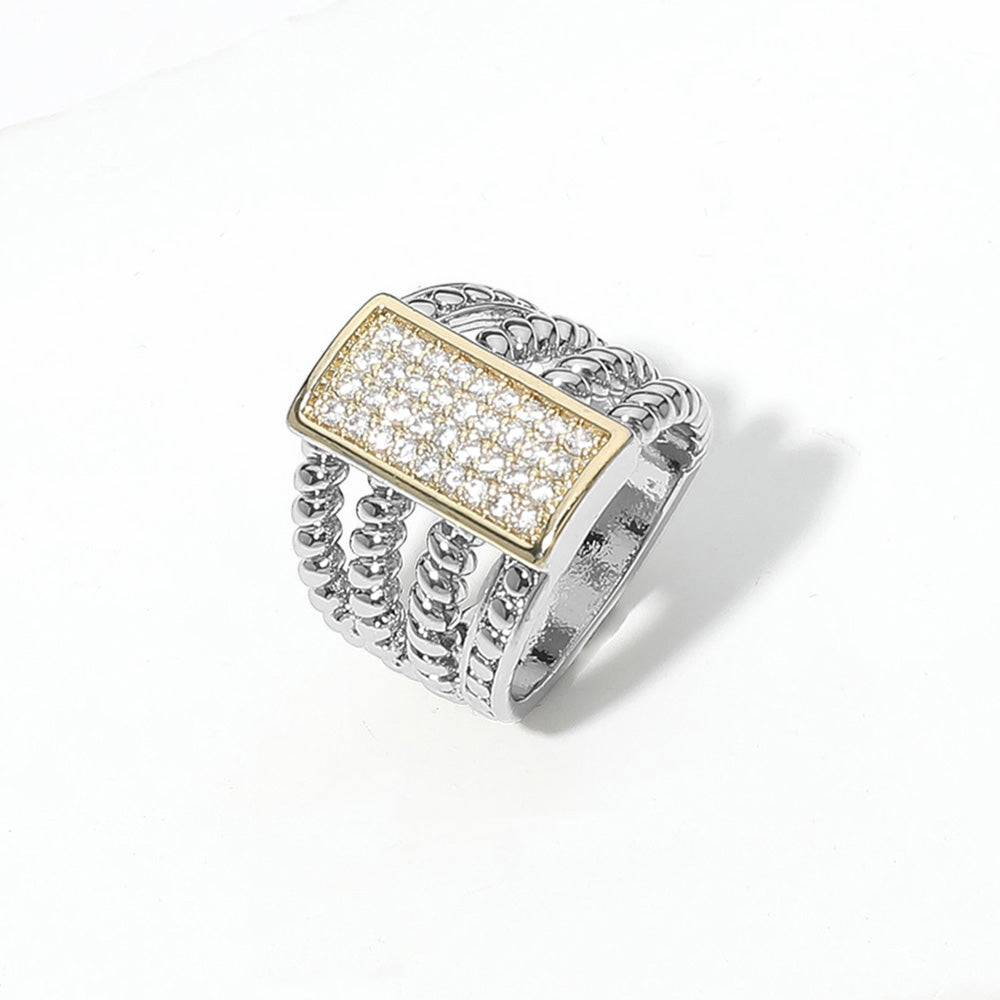 The Rosalie Ring offers bold texture and sparkle with a wide band, twisted detailing, and a pavé CZ rectangle—ideal for stacking or wearing solo.