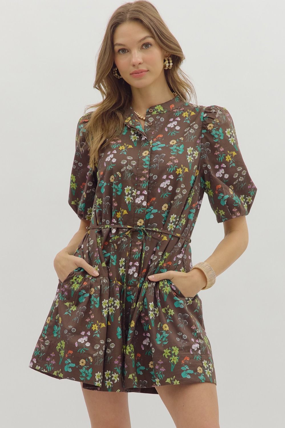 The Selah Floral Mini Dress features a charming floral print, short bubble sleeves, and a removable slim self belt for an effortlessly feminine look.

