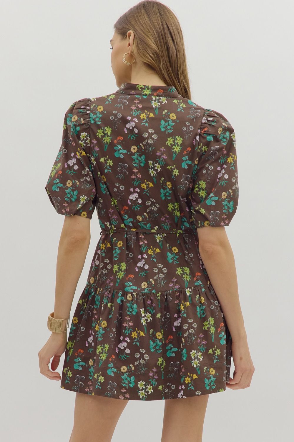 The Selah Floral Mini Dress features a charming floral print, short bubble sleeves, and a removable slim self belt for an effortlessly feminine look.

