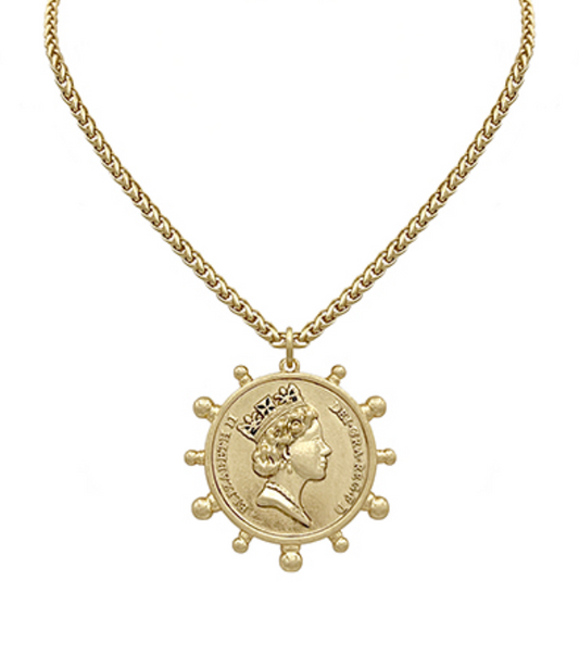  A gold-toned necklace with a substantial chain and a large circular pendant featuring a regal profile, possibly Queen Elizabeth II, encircled by decorative bumps and rimmed with text.