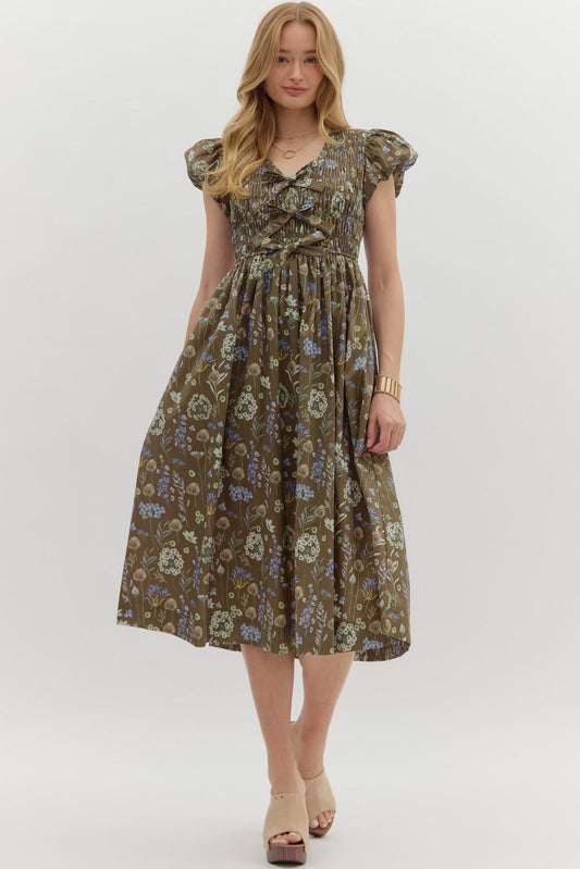 The Verona Dress is a romantic floral midi with puff sleeves, a smocked top, and bow detail—perfect for garden parties, weekend strolls, or everyday elegance.