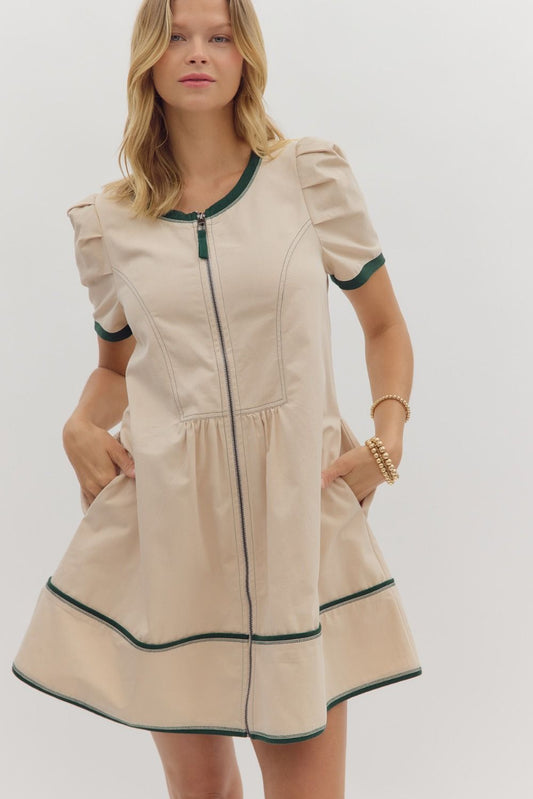 This structured cotton mini dress features pleated shoulders and contrast band detailing—an effortlessly chic option for back-to-school, transitional fall fashion, or a casual day out.

