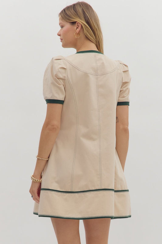 This structured cotton mini dress features pleated shoulders and contrast band detailing—an effortlessly chic option for back-to-school, transitional fall fashion, or a casual day out.

