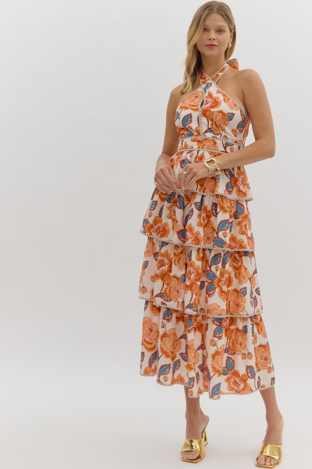 Tiered floral midi dress with a bow tie halter neckline, contrast binding, and smocked back.

