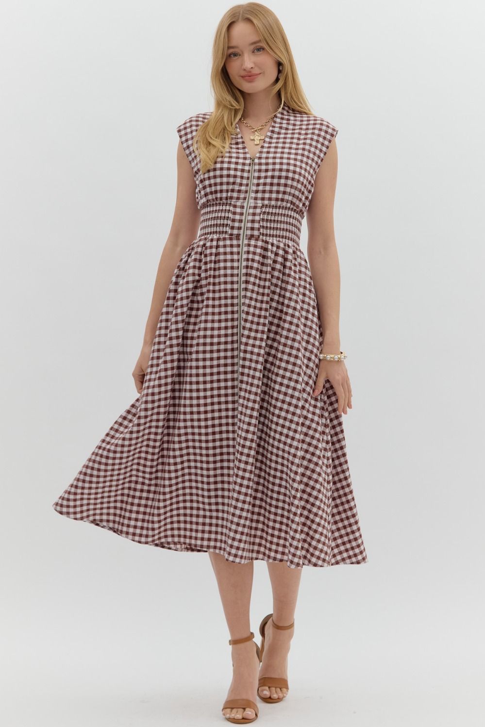 V-neck gingham midi dress with front zipper, smocked waist, and side pockets.
