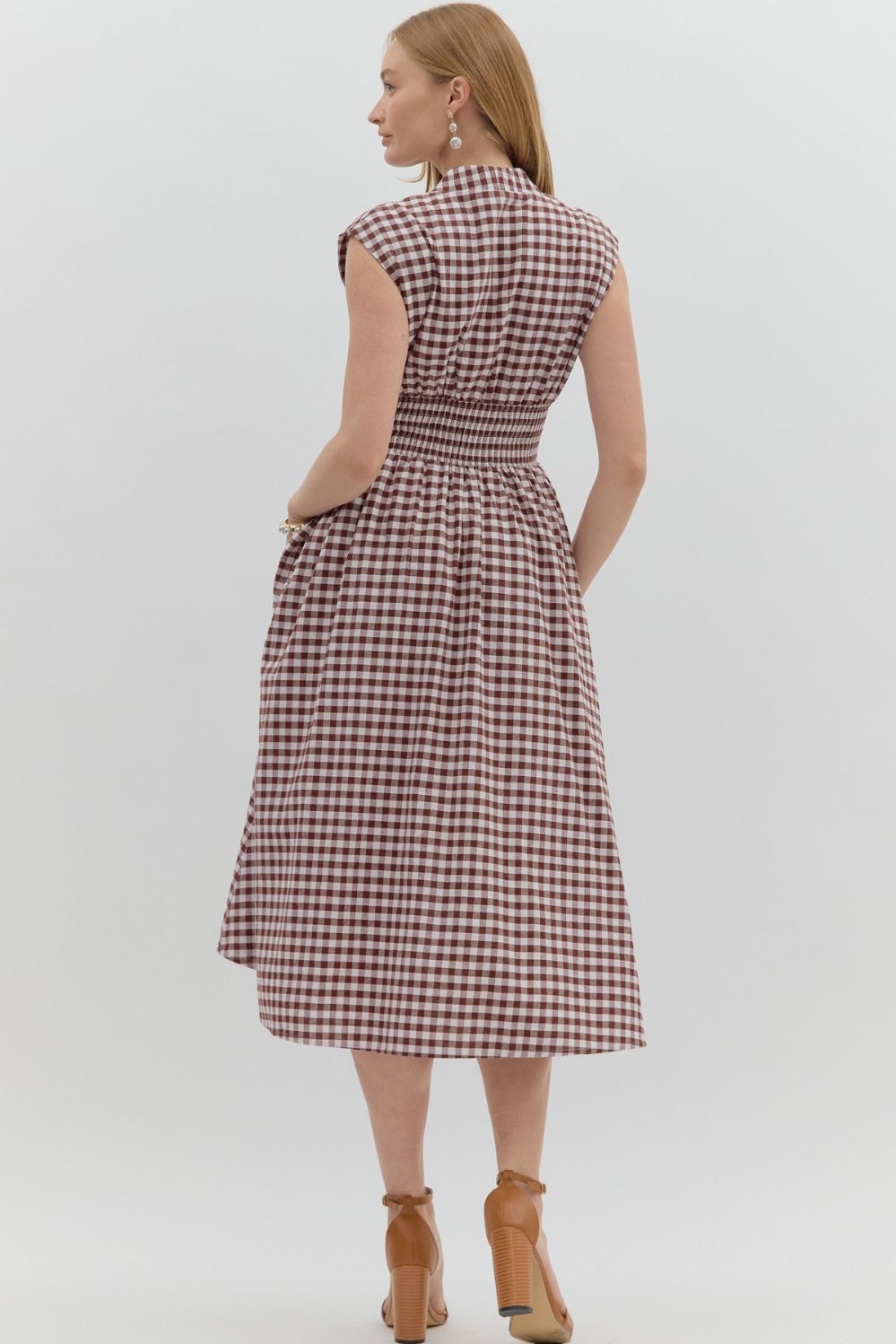 V-neck gingham midi dress with front zipper, smocked waist, and side pockets.

