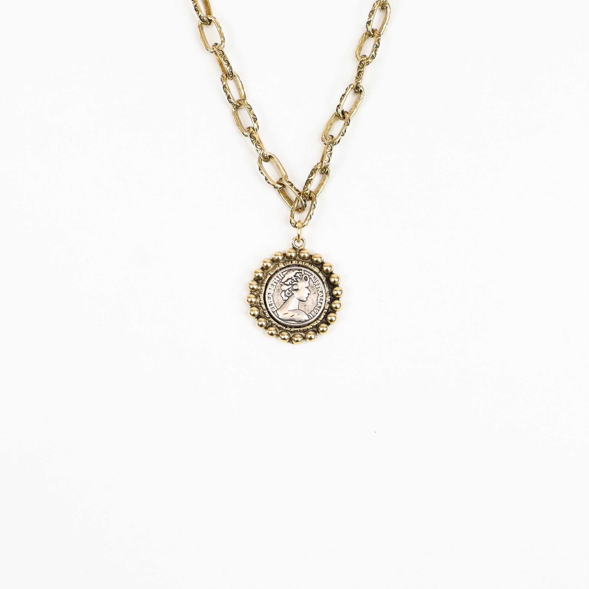 A 22K gold-plated Victorian-inspired medallion necklace featuring an antique-style cameo coin pendant with a beaded frame, suspended on a textured gold chain for a regal, vintage look.