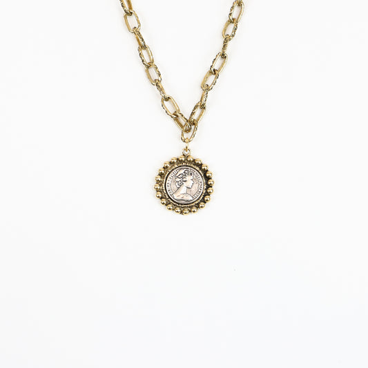 A 22K gold-plated Victorian-inspired medallion necklace featuring an antique-style cameo coin pendant with a beaded frame, suspended on a textured gold chain for a regal, vintage look.
