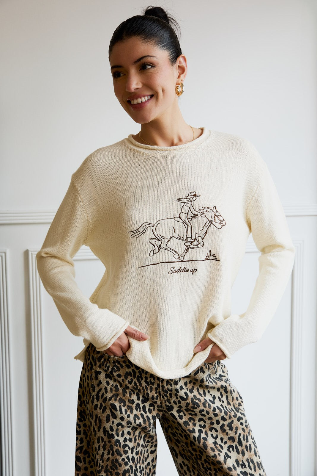 Western-inspired long sleeve sweater with a bold Saddle Up graphic.
